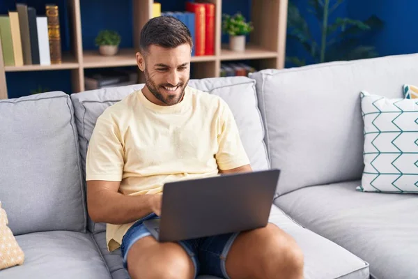 Young Hispanic Man Using Laptop Sitting Sofa Home — стоковое фото