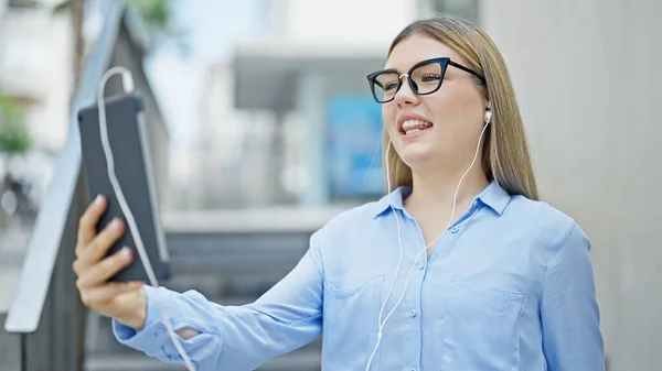 Young blonde woman business worker smiling confident having video call at street