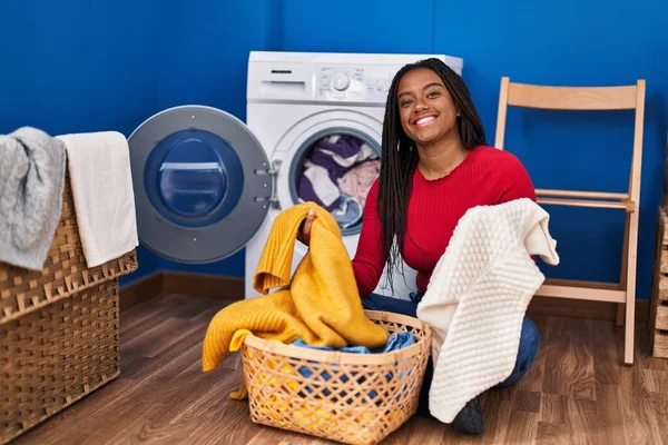 African American Woman Smiling Confident Washing Clothes Laundry Room — стоковое фото
