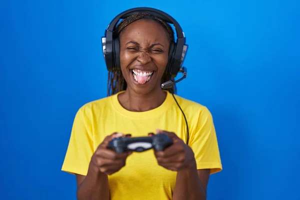 Африканская Американка Играющая Видеоигры Высунув Язык Довольна Смешным Выражением Лица — стоковое фото