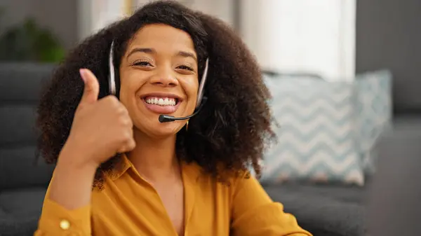 African american woman call center agent doing thumb up gesture working at home