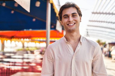 Young caucasian man smiling confident standing at street