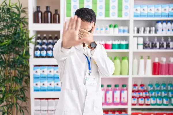 Handsome Hispanic Man Working Pharmacy Drugstore Covering Eyes Hands Doing — Stock Photo, Image