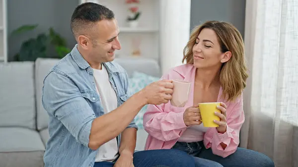 Man Woman Couple Drinking Coffee Sitting Sofa Home — стоковое фото