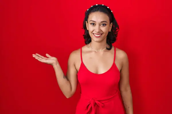 Young Hispanic Woman Standing Red Background Smiling Cheerful Presenting Pointing — Stock Photo, Image