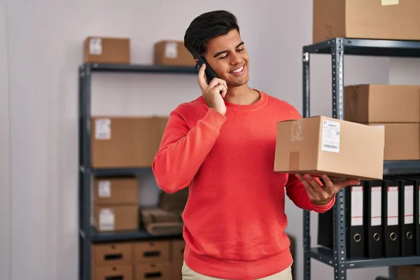 Young Hispanic Man Ecommerce Business Worker Talking Smartphone Holding Package — Foto de Stock