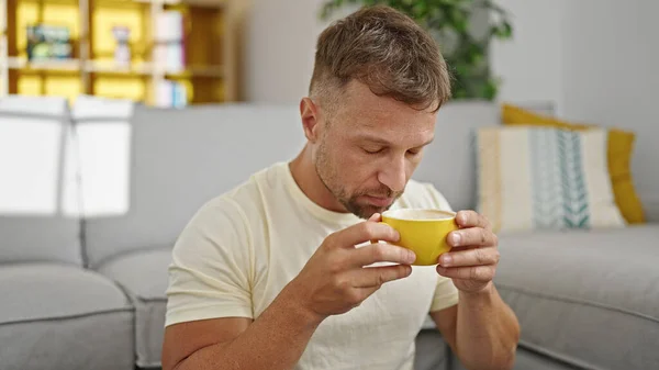 Young Man Smelling Cup Coffee Sitting Floor Home — Stock Photo, Image