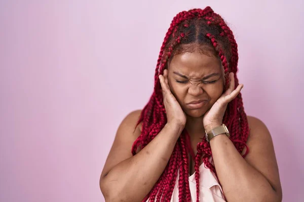 Африканская Американка Плетеными Волосами Стоящими Розовом Фоне Закрывает Уши Пальцами — стоковое фото