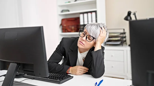 Young woman business worker tired working at office