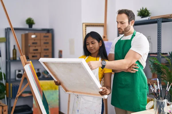 stock image Man and woman artist couple looking canvas draw at art studio