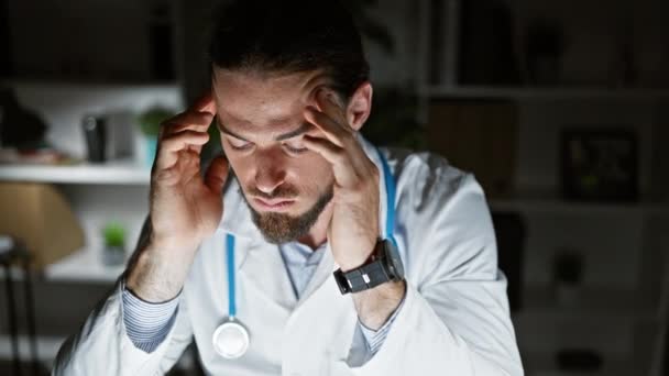 Jovem Hispânico Homem Médico Sofrendo Dor Cabeça Clínica — Vídeo de Stock