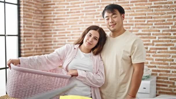 Man Woman Couple Smiling Confident Holding Basket Clothes Laundry Room — Vídeos de Stock