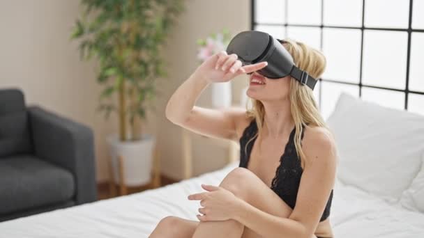 Young Blonde Woman Wearing Lingerie Using Virtual Reality Glasses Bedroom — Stockvideo