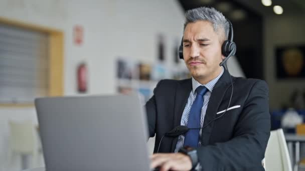 Young Hispanic Man Business Worker Using Laptop Headphones Office — Video Stock