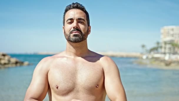 Young Hispanic Man Tourist Smiling Confident Standing Shirtless Arms Beach — Stock Video