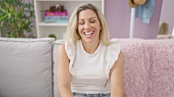 Junge Blonde Frau Lächelt Selbstbewusst Auf Sofa Hause — Stockvideo