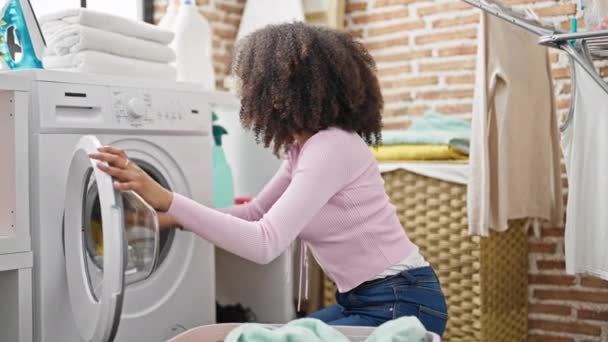 African American Woman Smelling Clean Clothes Laundry Room — Stock Video