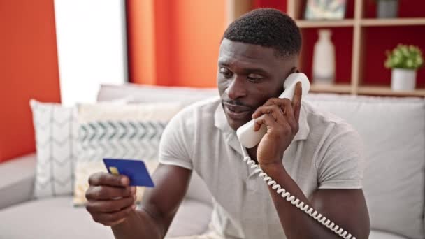 African American Man Talking Telephone Holding Credit Card Home — Stock Video