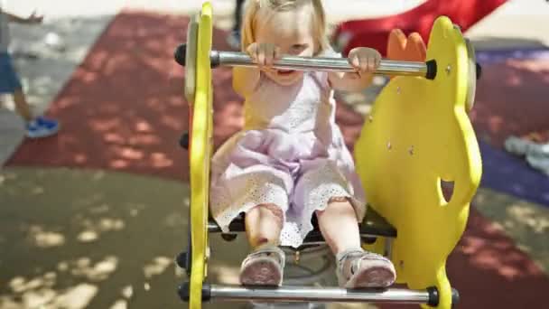Caucasian Baby Girl Playing Happy Sitting Swing Playground Park — Stock Video