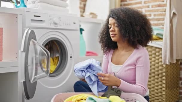 African American Woman Smelling Dirty Clothes Laundry Room — Stock Video