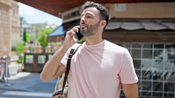 Young Hispanic Man Talking Smartphone Wearing Backpack Coffee Shop Terrace — Stock Video
