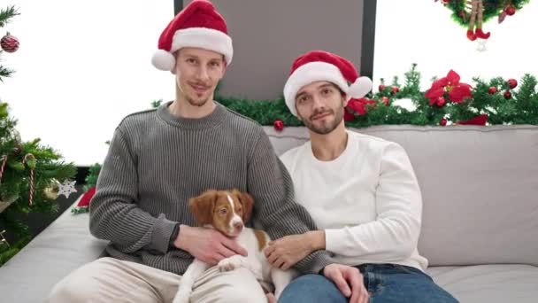 Dois Homens Casal Celebrando Natal Sentado Sofá Com Cão Casa — Vídeo de Stock