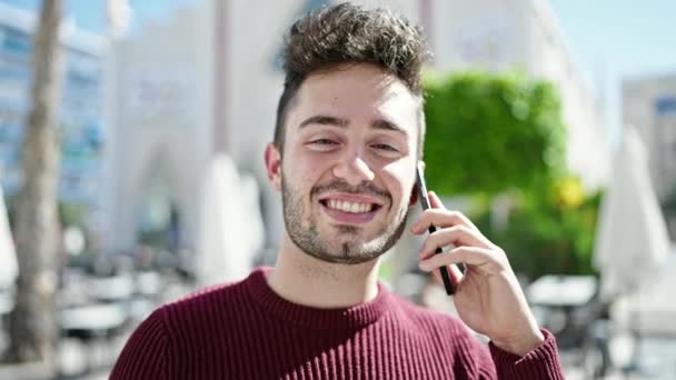Young Hispanic Man Smiling Confident Talking Smartphone Coffee Shop Terrace — 图库视频影像