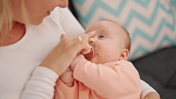 Mother Daughter Sitting Sofa Sucking Pacifier Touching Nose Home — Stock Video
