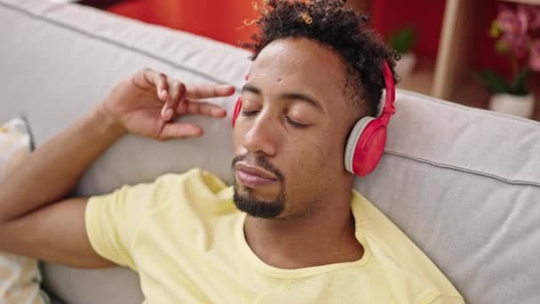 African American Man Listening Music Relaxed Sofa Home — Stock Video