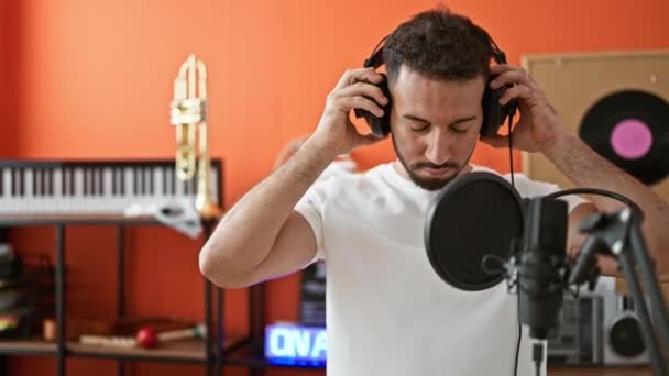 Young Arab Man Musician Wearing Headphones Singing Song Music Studio — Stock Video