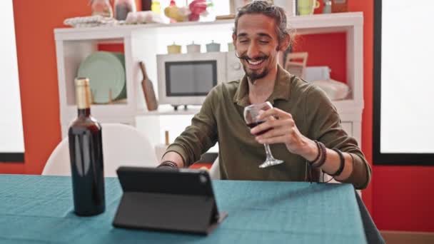 Jonge Spaanse Man Drinken Glas Wijn Kijken Video Touchpad Eetkamer — Stockvideo
