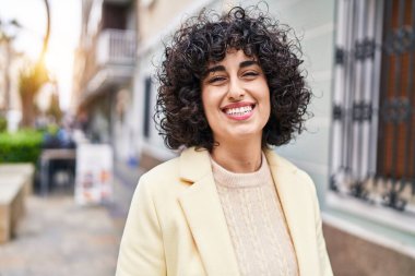 Young middle east woman excutive smiling confident standing at street