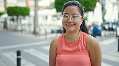 Young chinese woman smiling confident standing at street