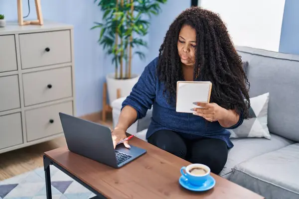 African American Woman Using Laptop Reading Notebook Home — Stockfoto