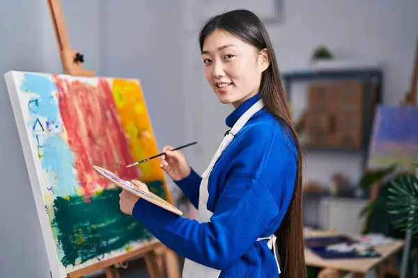 Chinese woman artist smiling confident drawing at art studio