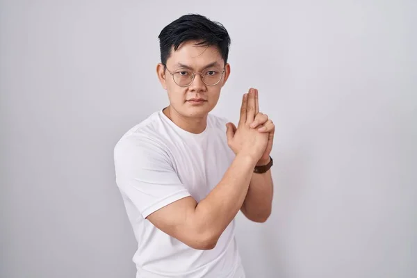 Young Asian Man Standing White Background Holding Symbolic Gun Hand — Stock Photo, Image