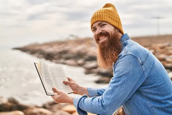 Young Redhead Man Smiling Confident Reading Book Seaside — Stock Photo, Image