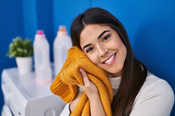 Young Beautiful Hispanic Woman Smiling Confident Touching Softener Clothes Face — Fotografia de Stock