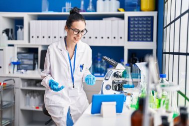 Young caucasian woman scientist having video call at laboratory