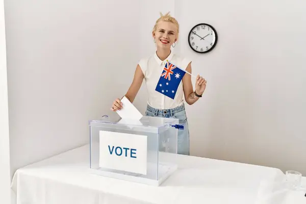 stock image Young blonde woman holding australian flag voting at electoral college