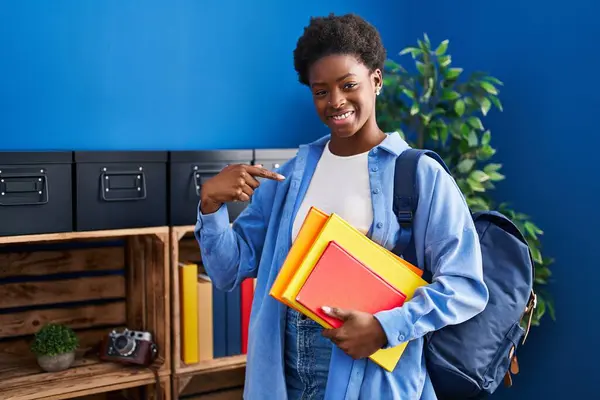 African American Woman Wearing Student Backpack Holding Books Pointing Finger — Stock Photo, Image