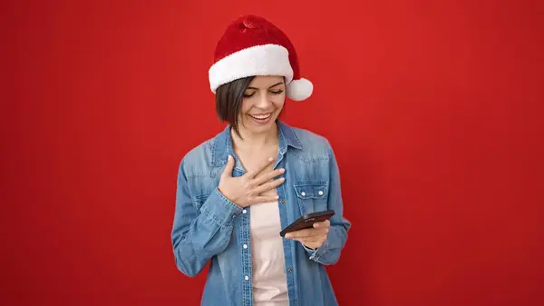 Young Caucasian Woman Wearing Christmas Hat Using Smartphone Isolated Red — Stock Photo, Image
