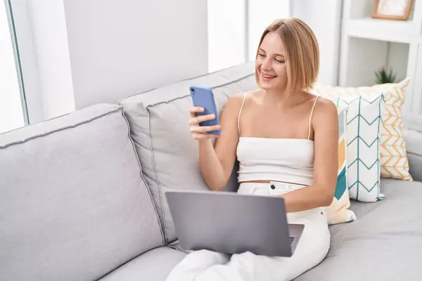 Young Blonde Woman Using Laptop Smartphone Home — Stok fotoğraf