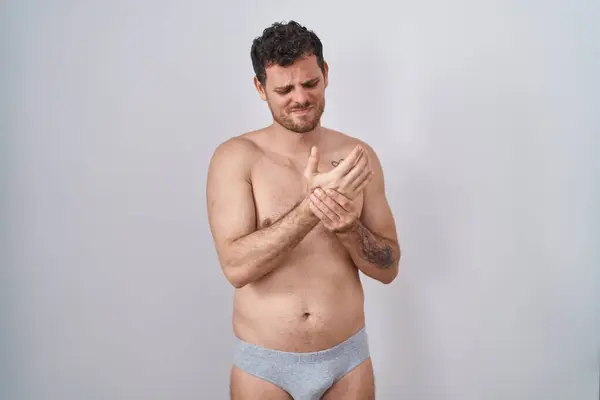 Young Hispanic Man Standing Shirtless Wearing Underware Suffering Pain Hands — Stock Photo, Image