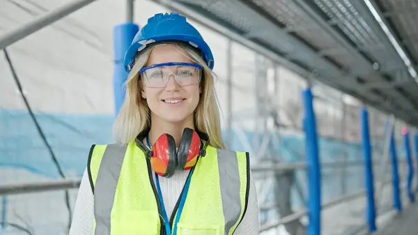 Young blonde woman architect smiling confident standing at street