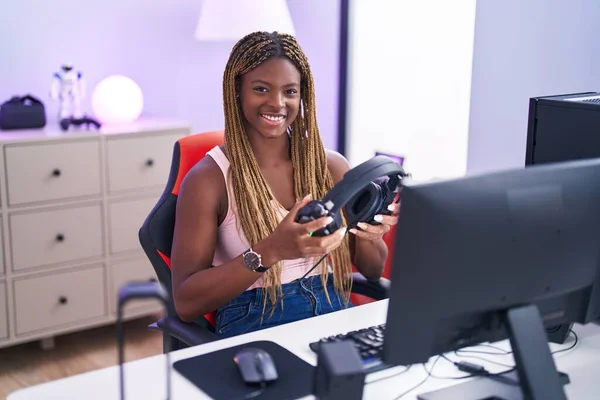 African American Woman Streamer Smiling Confident Holding Headphones Gaming Room — Stock Photo, Image