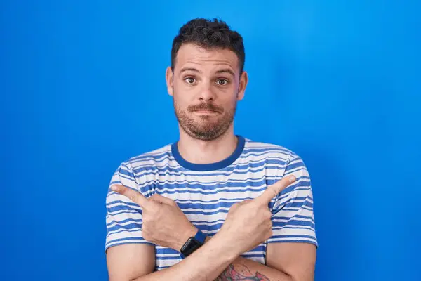 Young Hispanic Man Standing Blue Background Pointing Both Sides Fingers — Stock Photo, Image