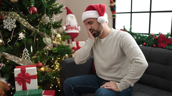 Young Hispanic Man Suffering Headache Sitting Christmas Tree Home — Stock Photo, Image