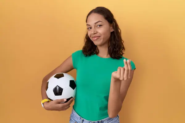 Young Hispanic Woman Holding Ball Doing Money Gesture Hands Asking — Stock Photo, Image