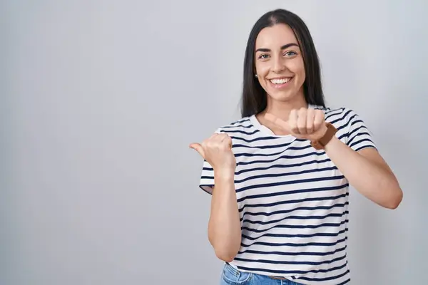 Young Brunette Woman Wearing Striped Shirt Pointing Back Hand Thumbs — Stock Photo, Image